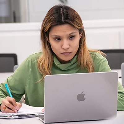 a student works on a laptop